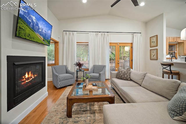 225 Laclede Ct, Colorado Springs, CO 80905 - living area featuring ceiling fan, vaulted ceiling, light wood finished floors, plenty of natural light, and french doors
