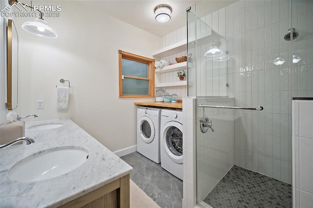 225 Laclede Ct, Colorado Springs, CO 80905 - bathroom featuring washing machine and dryer, a shower stall, and double vanity