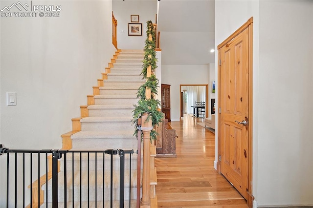 225 Laclede Ct, Colorado Springs, CO 80905 - stairway featuring wood finished floors, a high ceiling, and recessed lighting
