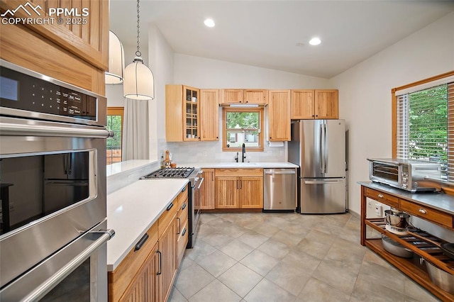 225 Laclede Ct, Colorado Springs, CO 80905 - kitchen featuring appliances with stainless steel finishes, light countertops, lofted ceiling, backsplash, and glass insert cabinets