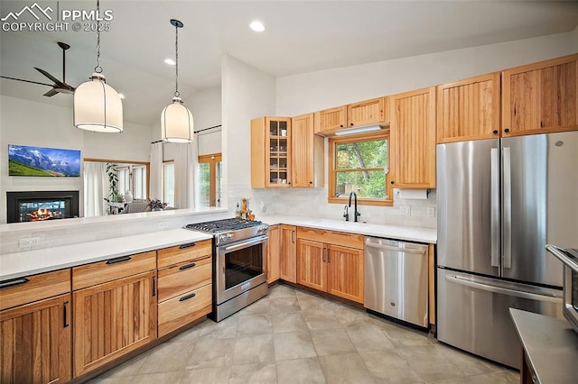 225 Laclede Ct, Colorado Springs, CO 80905 - kitchen featuring appliances with stainless steel finishes, tasteful backsplash, light countertops, glass insert cabinets, and pendant lighting