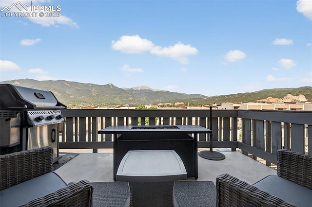 910 Fontmore Rd Unit D, Colorado Springs, CO 80904 - deck featuring a mountain view, grilling area, and an outdoor hangout area