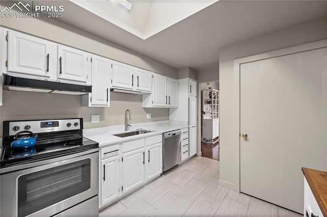 910 Fontmore Rd Unit D, Colorado Springs, CO 80904 - kitchen with stainless steel appliances, under cabinet range hood, white cabinetry, and light countertops