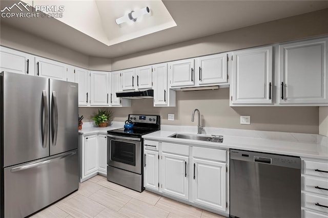 910 Fontmore Rd Unit D, Colorado Springs, CO 80904 - kitchen featuring appliances with stainless steel finishes, under cabinet range hood, light countertops, and white cabinetry