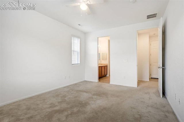4887 Wolf Moon Dr, Colorado Springs, CO 80911 - unfurnished bedroom featuring light colored carpet, connected bathroom, and ceiling fan