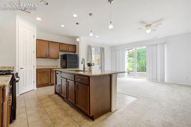 4887 Wolf Moon Dr, Colorado Springs, CO 80911 - kitchen with black appliances, a ceiling fan, light stone counters, pendant lighting, and recessed lighting