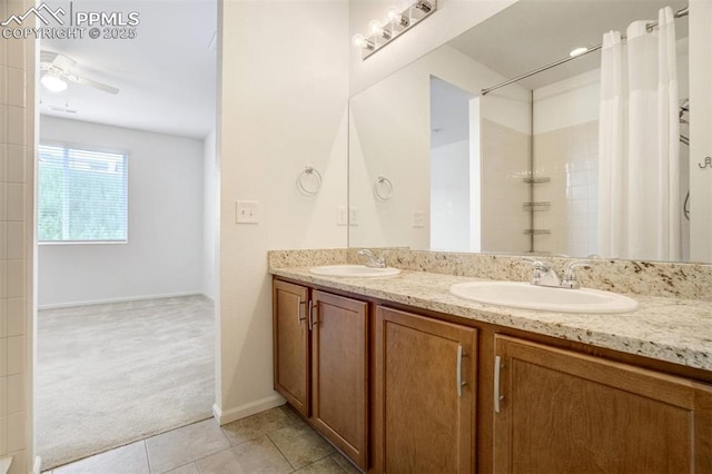 4887 Wolf Moon Dr, Colorado Springs, CO 80911 - bathroom with double vanity, tile patterned flooring, curtained shower, and ceiling fan