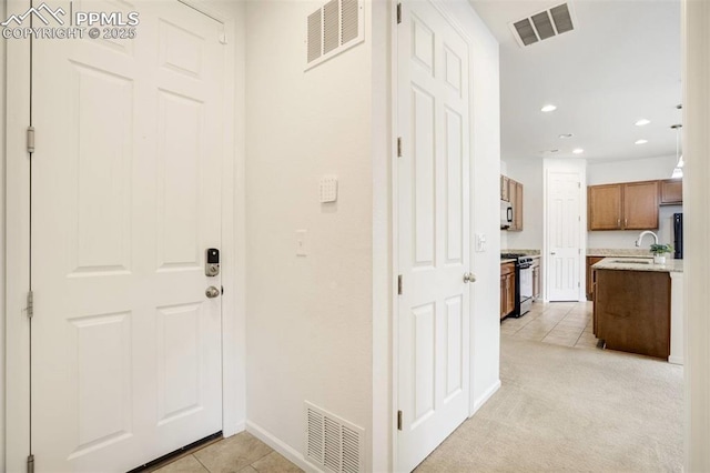 4887 Wolf Moon Dr, Colorado Springs, CO 80911 - foyer entrance with light tile patterned floors and recessed lighting