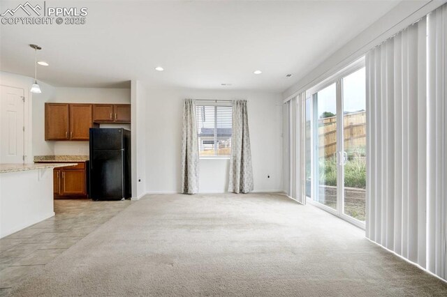 4887 Wolf Moon Dr, Colorado Springs, CO 80911 - unfurnished living room with recessed lighting and light colored carpet