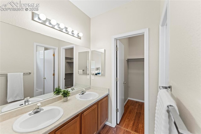3025 Ebbtide Vw, Colorado Springs, CO 80922 - full bath featuring double vanity, wood finished floors, and a spacious closet