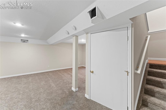 3025 Ebbtide Vw, Colorado Springs, CO 80922 - finished below grade area with carpet, stairway, and a textured ceiling