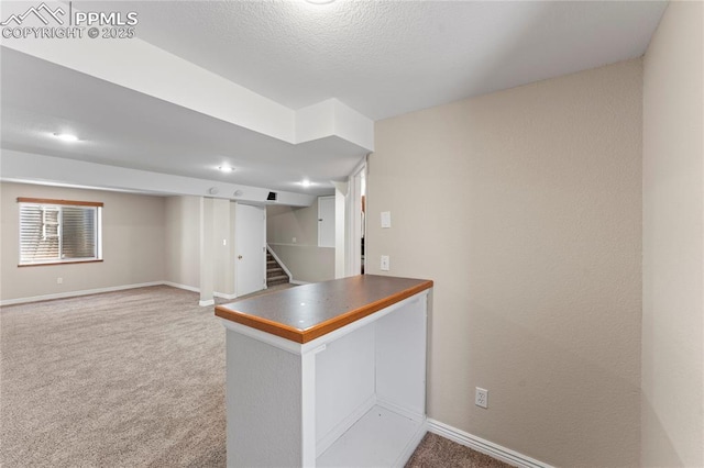 3025 Ebbtide Vw, Colorado Springs, CO 80922 - interior space featuring carpet floors, a peninsula, dark countertops, and a textured ceiling