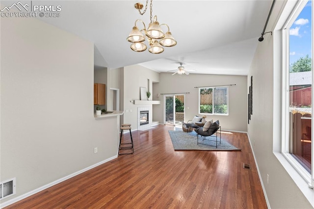 3025 Ebbtide Vw, Colorado Springs, CO 80922 - living room with a chandelier, a ceiling fan, wood finished floors, a glass covered fireplace, and lofted ceiling