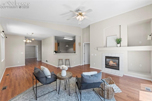 3025 Ebbtide Vw, Colorado Springs, CO 80922 - living area featuring wood finished floors, a fireplace, and a ceiling fan