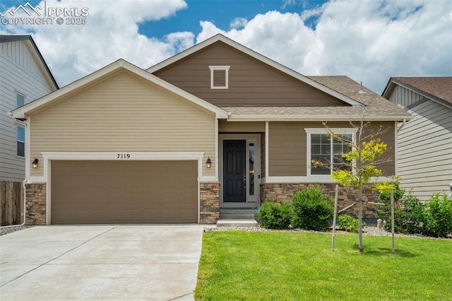 7119 Passing Sky Dr, Colorado Springs, CO 80911 - view of front of home featuring stone siding, a front yard, an attached garage, driveway, and a shingled roof