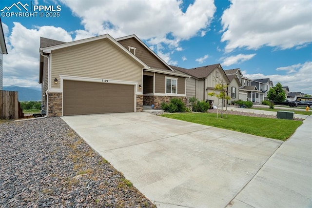 7119 Passing Sky Dr, Colorado Springs, CO 80911 - view of front facade featuring a residential view, concrete driveway, stone siding, and an attached garage