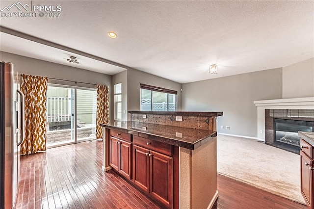2513 Gilpin Ave, Colorado Springs, CO 80910 - kitchen with plenty of natural light, freestanding refrigerator, dark wood-style flooring, open floor plan, and recessed lighting