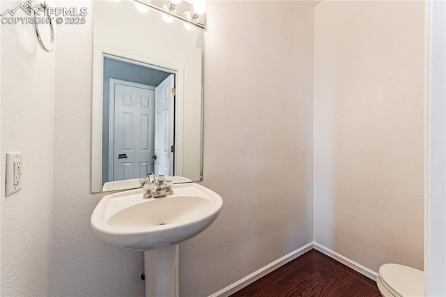 2513 Gilpin Ave, Colorado Springs, CO 80910 - bathroom with toilet and wood finished floors