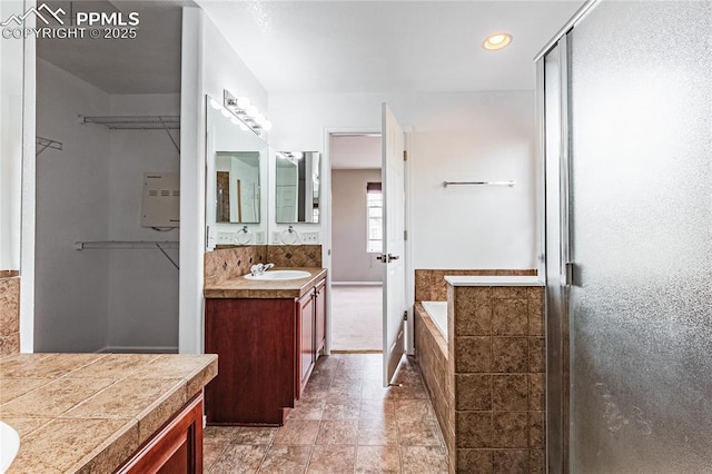 2513 Gilpin Ave, Colorado Springs, CO 80910 - full bathroom with vanity, a garden tub, a stall shower, and recessed lighting