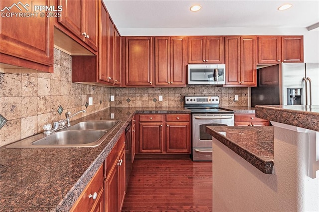 2513 Gilpin Ave, Colorado Springs, CO 80910 - kitchen featuring stainless steel appliances, dark wood-style floors, tile countertops, backsplash, and recessed lighting