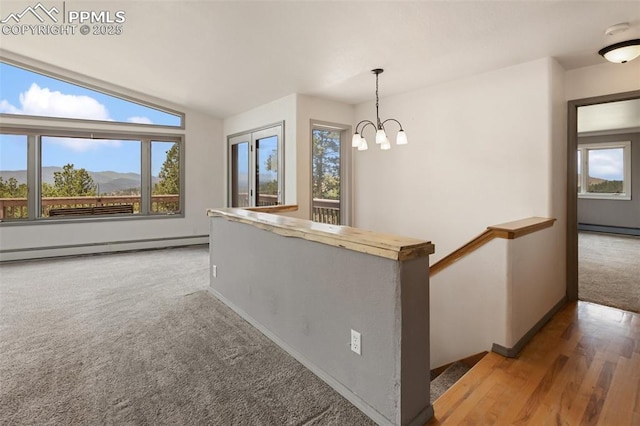 517 Drees Dr, Florissant, CO 80816 - hall with a baseboard heating unit, plenty of natural light, a chandelier, and vaulted ceiling