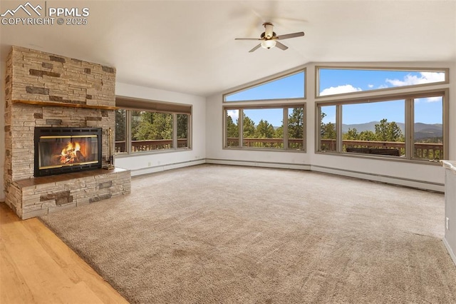 517 Drees Dr, Florissant, CO 80816 - unfurnished living room featuring a ceiling fan, vaulted ceiling, a stone fireplace, and a mountain view
