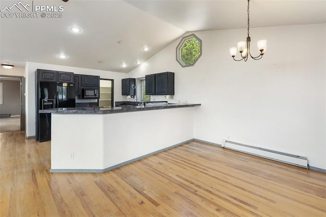 517 Drees Dr, Florissant, CO 80816 - kitchen featuring a baseboard heating unit, black appliances, a peninsula, lofted ceiling, and light wood-style flooring