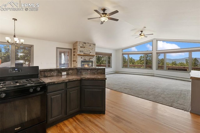 517 Drees Dr, Florissant, CO 80816 - kitchen featuring black gas stove, ceiling fan, light wood finished floors, lofted ceiling, and a chandelier