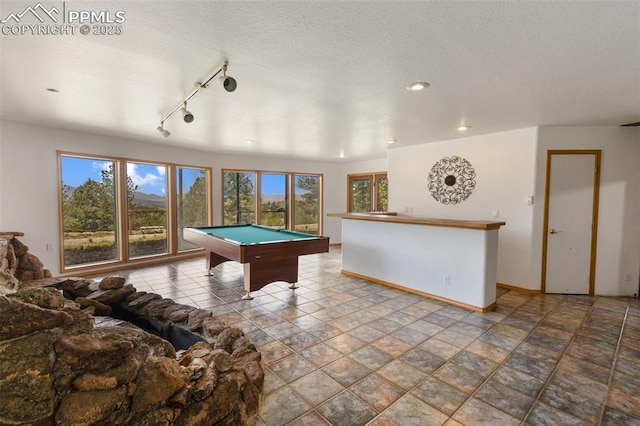 517 Drees Dr, Florissant, CO 80816 - game room with pool table, a textured ceiling, recessed lighting, rail lighting, and stone finish floors