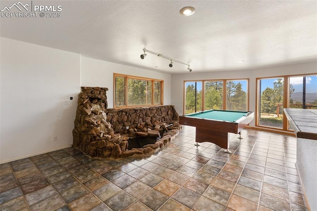 517 Drees Dr, Florissant, CO 80816 - playroom featuring billiards, a textured ceiling, and stone finish flooring