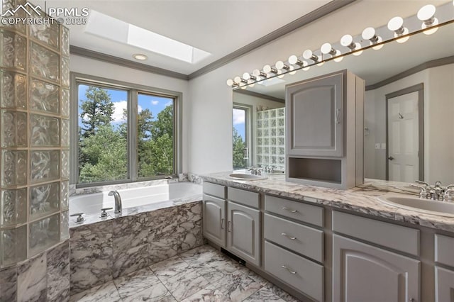 517 Drees Dr, Florissant, CO 80816 - bathroom with ornamental molding, double vanity, a bath, marble finish floors, and a skylight