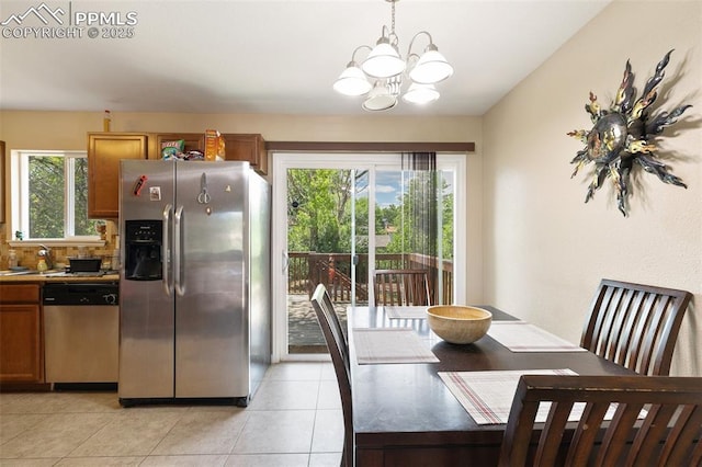 614 Bickley St, Colorado Springs, CO 80911 - dining space featuring plenty of natural light, a chandelier, and light tile patterned flooring