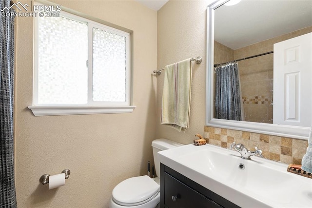 614 Bickley St, Colorado Springs, CO 80911 - full bath featuring vanity, a shower with shower curtain, decorative backsplash, and a textured wall