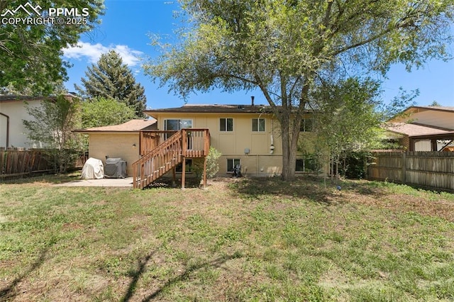 614 Bickley St, Colorado Springs, CO 80911 - back of property featuring a fenced backyard and stairway