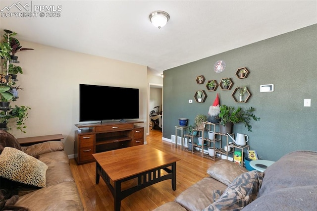 614 Bickley St, Colorado Springs, CO 80911 - living room featuring wood finished floors and baseboards