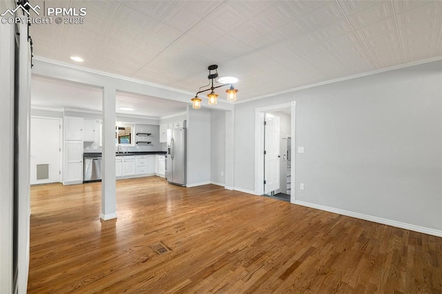 1406 N Foote Ave, Colorado Springs, CO 80909 - unfurnished living room with light wood-type flooring and crown molding