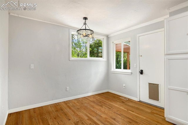 1406 N Foote Ave, Colorado Springs, CO 80909 - unfurnished room with a chandelier, light wood-type flooring, and ornamental molding