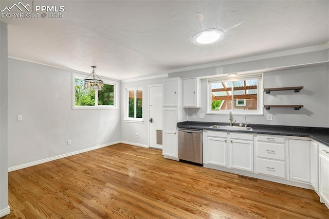 1406 N Foote Ave, Colorado Springs, CO 80909 - kitchen featuring stainless steel dishwasher, ornamental molding, dark countertops, white cabinetry, and light wood-type flooring