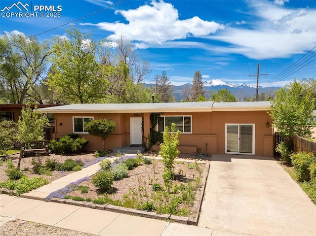 1406 N Foote Ave, Colorado Springs, CO 80909 - single story home with a mountain view, stucco siding, and driveway