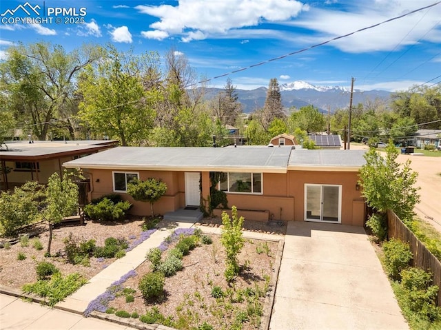 1406 N Foote Ave, Colorado Springs, CO 80909 - ranch-style house featuring a mountain view, concrete driveway, and stucco siding