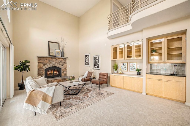 19170 Lochmere Ct, Monument, CO 80132 - living room with a high ceiling, light colored carpet, and a stone fireplace