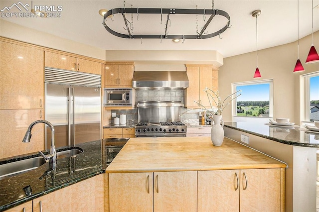 19170 Lochmere Ct, Monument, CO 80132 - kitchen featuring built in appliances, wall chimney exhaust hood, light brown cabinetry, and backsplash