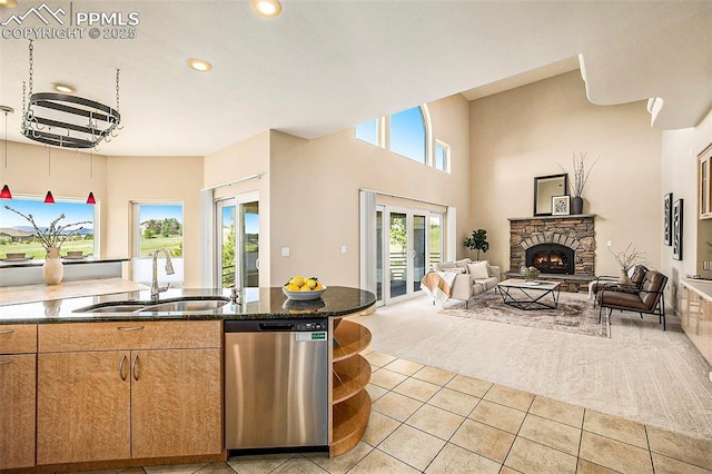 19170 Lochmere Ct, Monument, CO 80132 - kitchen featuring dishwasher, light colored carpet, light tile patterned floors, open floor plan, and a stone fireplace