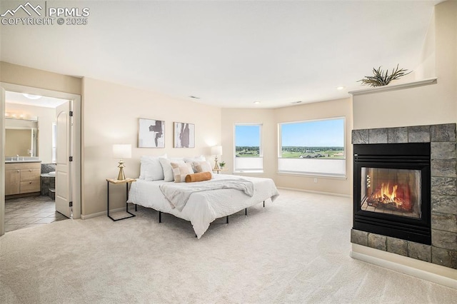 19170 Lochmere Ct, Monument, CO 80132 - bedroom with light colored carpet, a tile fireplace, and connected bathroom