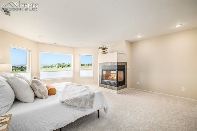 19170 Lochmere Ct, Monument, CO 80132 - bedroom featuring light carpet, a multi sided fireplace, and recessed lighting