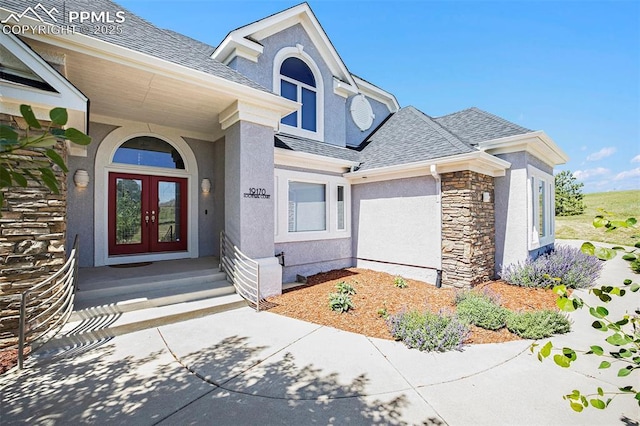 19170 Lochmere Ct, Monument, CO 80132 - entrance to property with stucco siding, a shingled roof, french doors, and stone siding