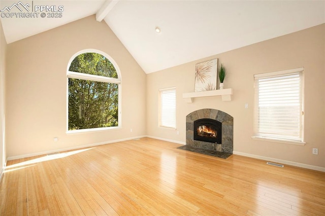 19170 Lochmere Ct, Monument, CO 80132 - unfurnished living room featuring beam ceiling, hardwood / wood-style floors, a fireplace, and high vaulted ceiling