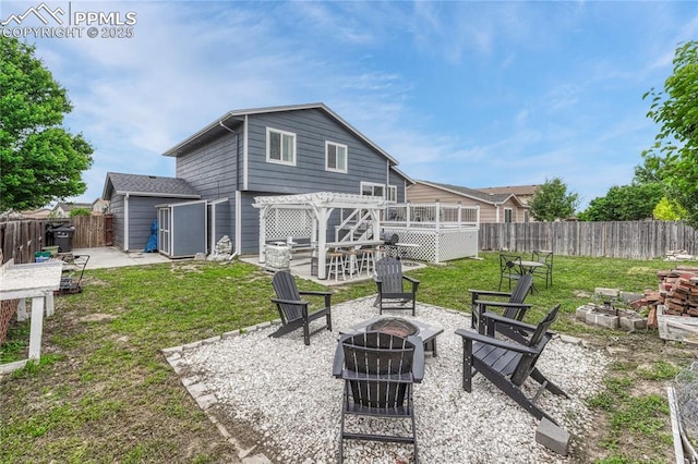 7262 Lone Eagle Ln, Colorado Springs, CO 80925 - back of property with an outdoor fire pit, a fenced backyard, a patio, and a deck
