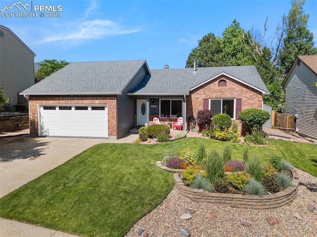 3470 Whimbrel Ln, Colorado Springs, CO 80906 - view of front facade with brick siding, a shingled roof, an attached garage, and driveway