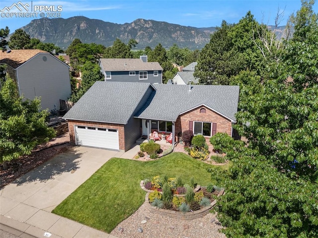 3470 Whimbrel Ln, Colorado Springs, CO 80906 - view of front of home featuring brick siding, a garage, concrete driveway, a shingled roof, and a front yard